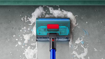 Dyson W1 PencilWash cleaner cleaning to the edge on a hard floor. Dyson W1 PencilWash cleaner cleaning to the edge on a hard floor.