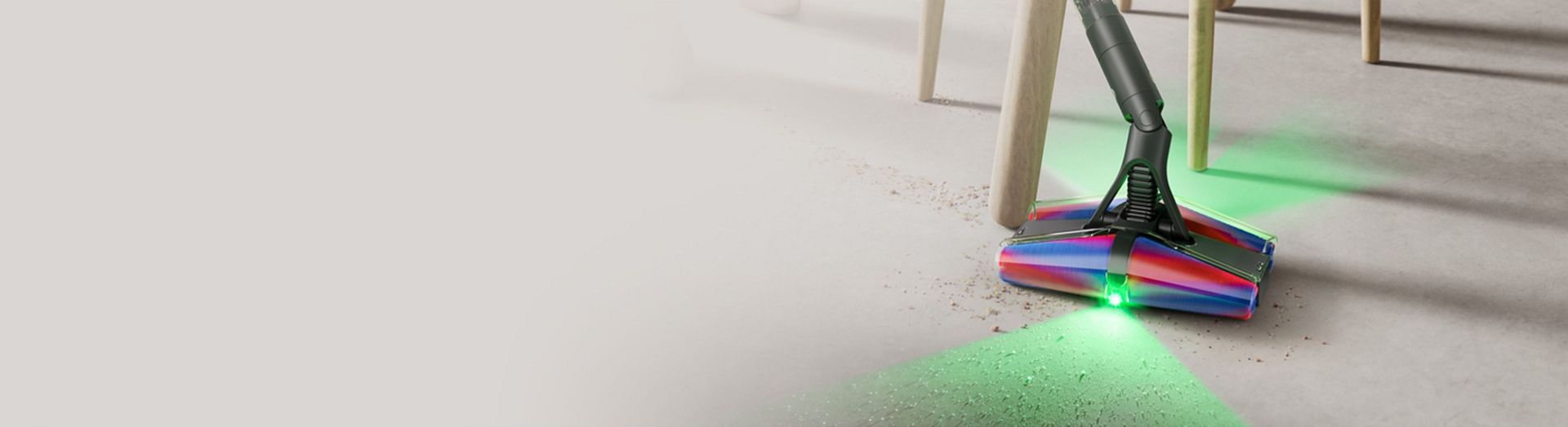 The Dyson PencilVac Fluffycones cleaner cleans around the legs of a chair.