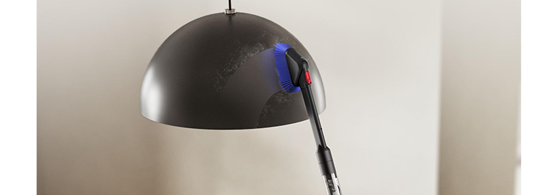 Dyson PencilVac cleaner used to clean a ceiling lampshade.