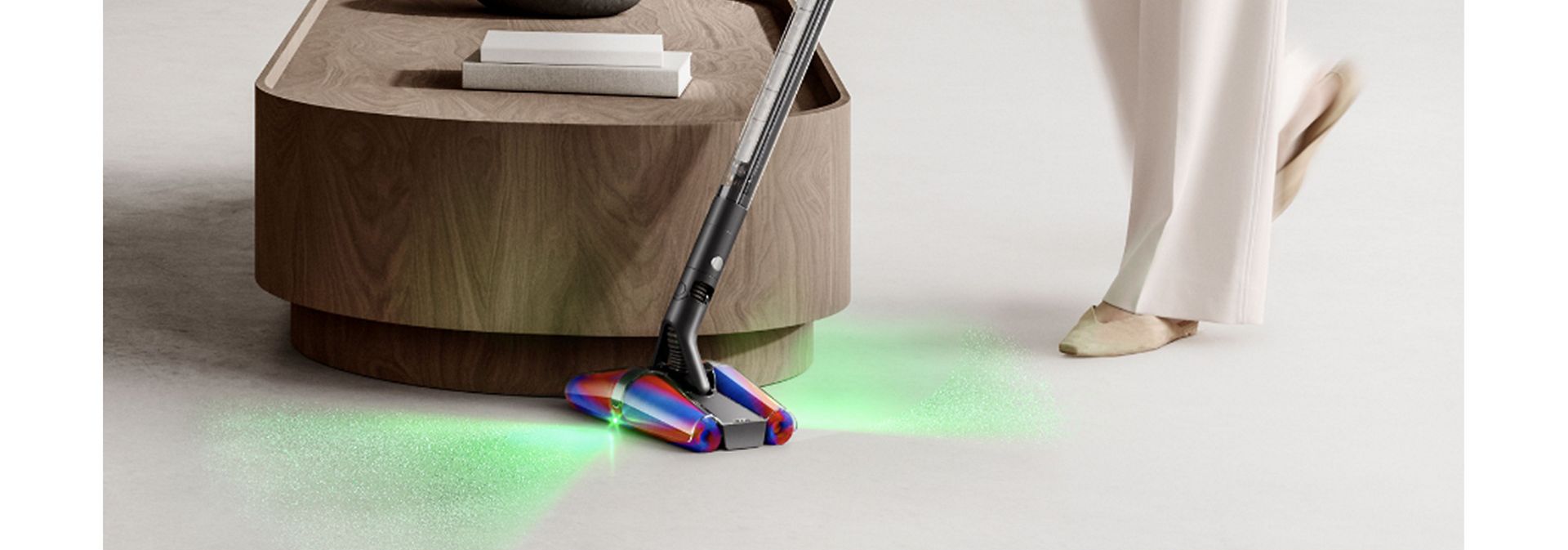 Dyson PencilVac cleaner used to clean around a coffee table in a home.