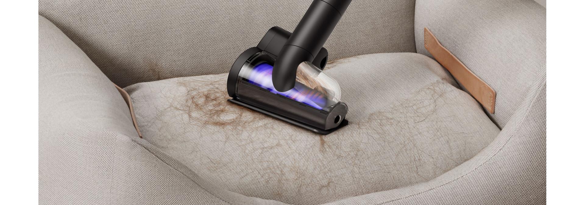 Dyson Hair screw tool used to clean fur from a pet bed.