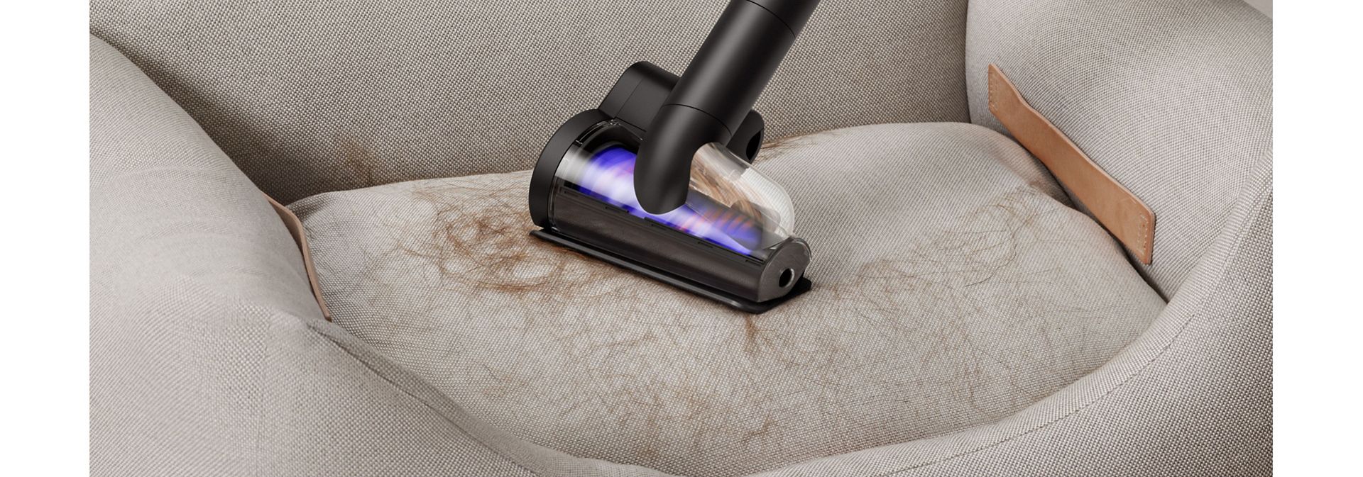 Dyson Hair screw tool used to clean fur from a pet bed.