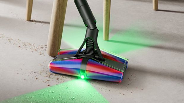 Dyson Fluffycones cleaner head used to clean around the legs of a chair.