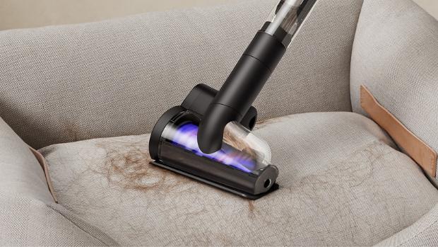 Dyson Hair screw tool used to clean fur from a pet bed.