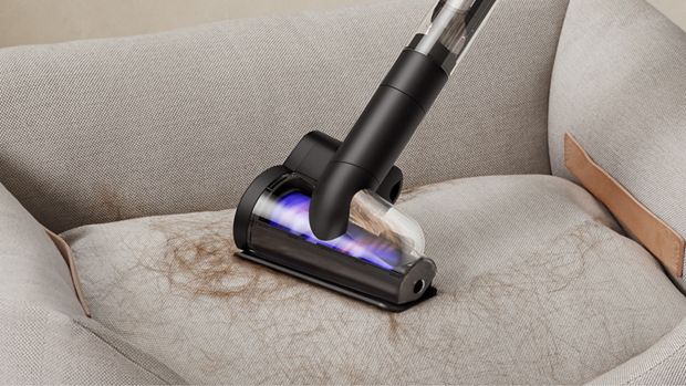 Dyson Hair screw tool used to clean fur from a pet bed.