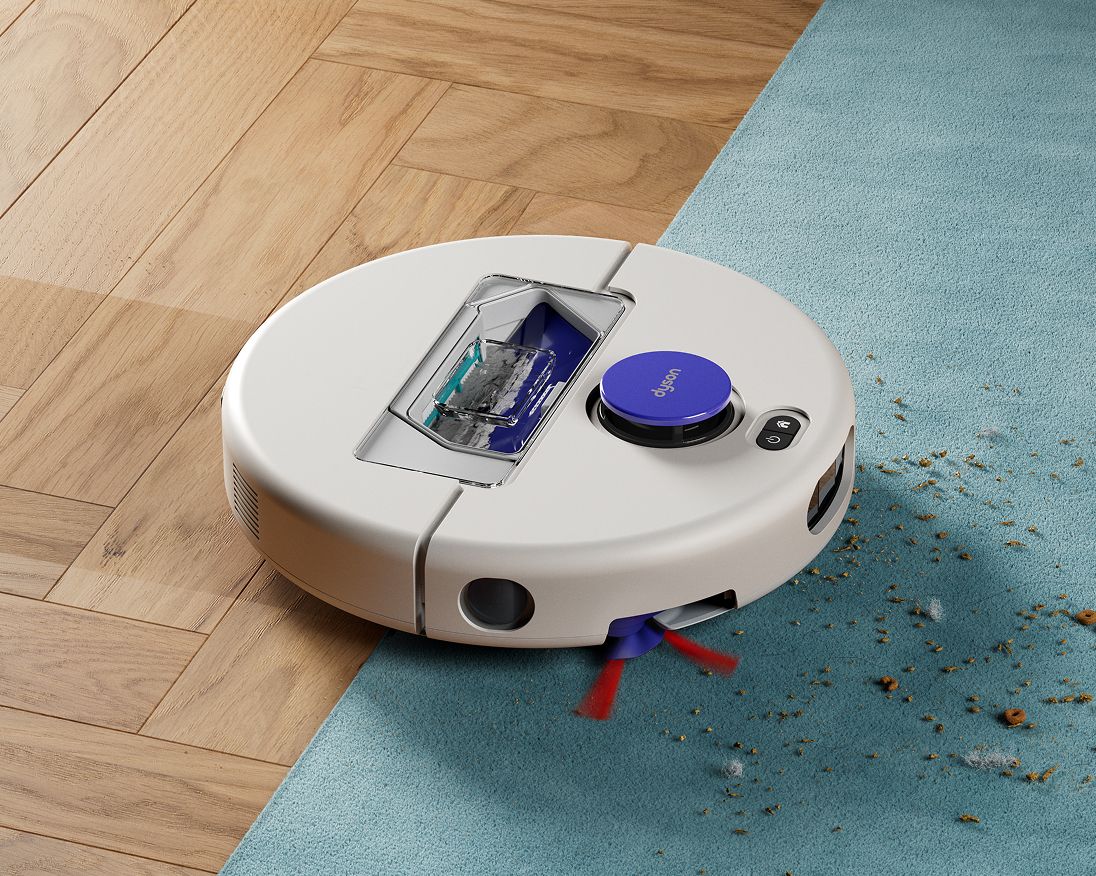 A Dyson R1 Nurovi or R2 Nurovi robot vacuum cleaner cleaning between hard floors and carpet. A Dyson R1 Nurovi or R2 Nurovi robot vacuum cleaner cleaning between hard floors and carpet.