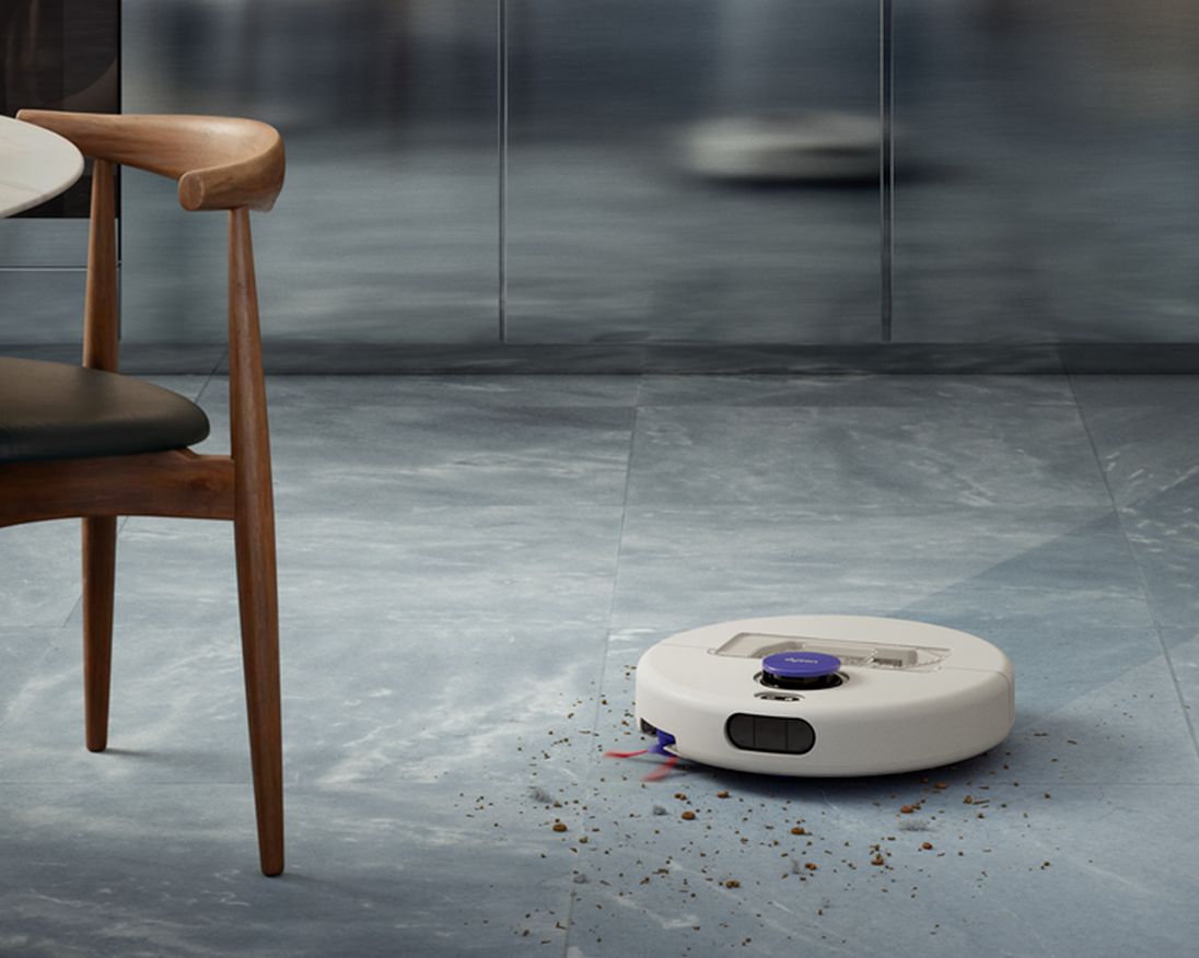 A Dyson R1 Nurovi or R2 Nurovi robot vacuum cleaner cleaning a hard floor. A Dyson R1 Nurovi or R2 Nurovi robot vacuum cleaner cleaning a hard floor.
