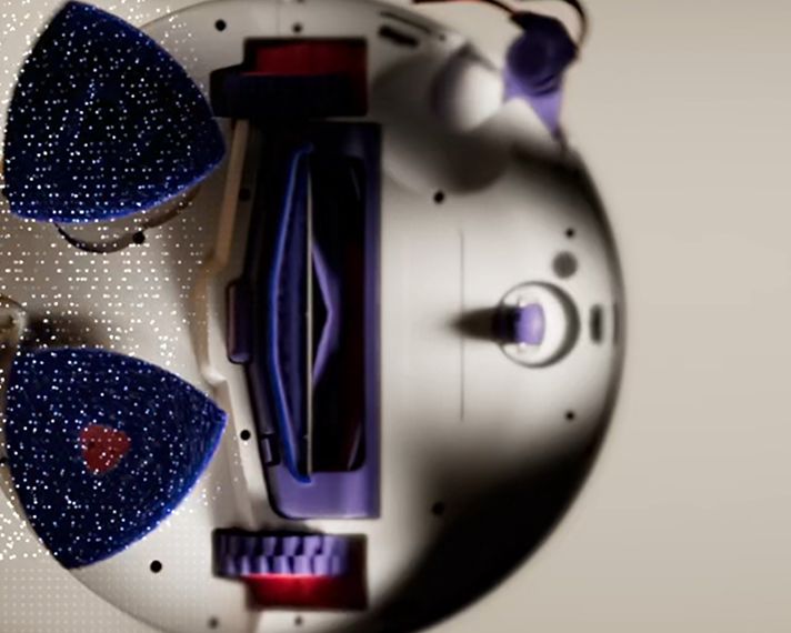 Close-up of the Reuleaux triangle wash pad on the Dyson R2 Nurovi Wash+Dry robot vacuum cleaner.