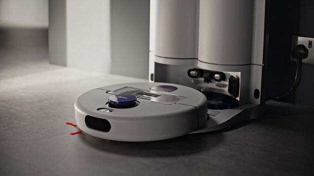Dyson R2 Nurovi Wash+Dry robot vacuum emerging from its dock.