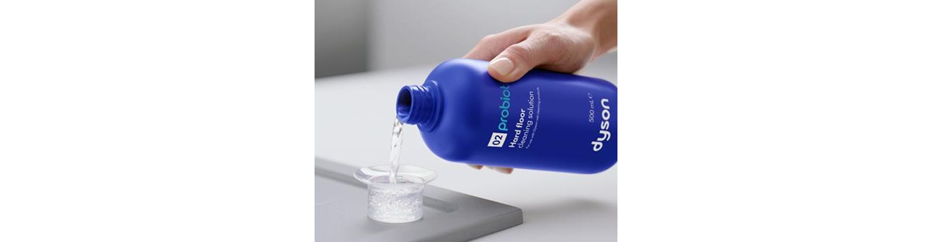 Dyson 01 Hard floor cleaning solution is decanted into a measuring cup.