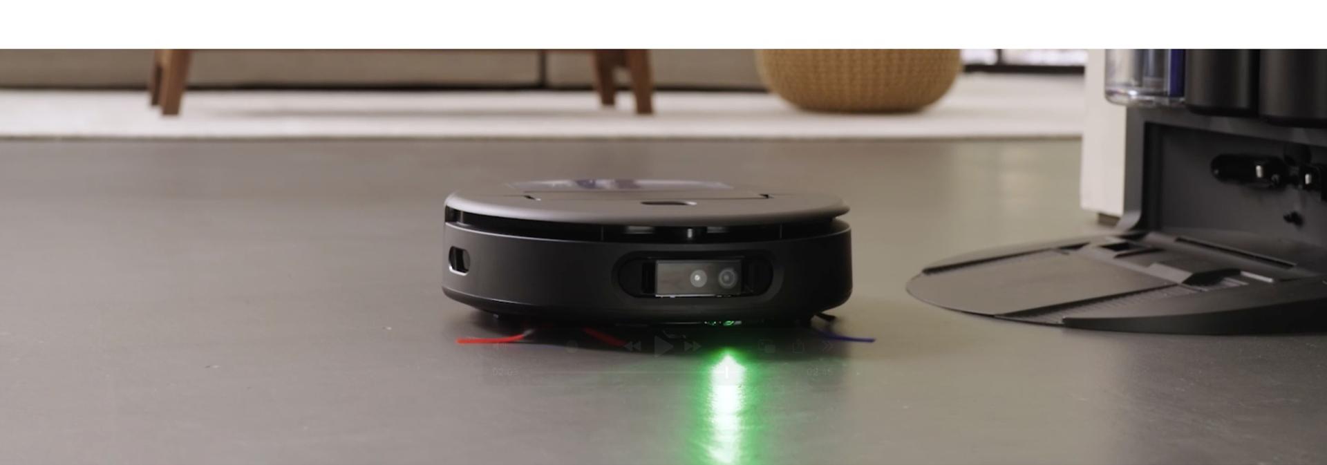 The Dyson Spot+Scrub Ai robot vacuum cleans near its docking station.