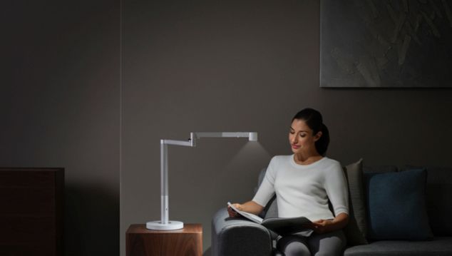 Woman reading under Dyson Solarcycle Morph light