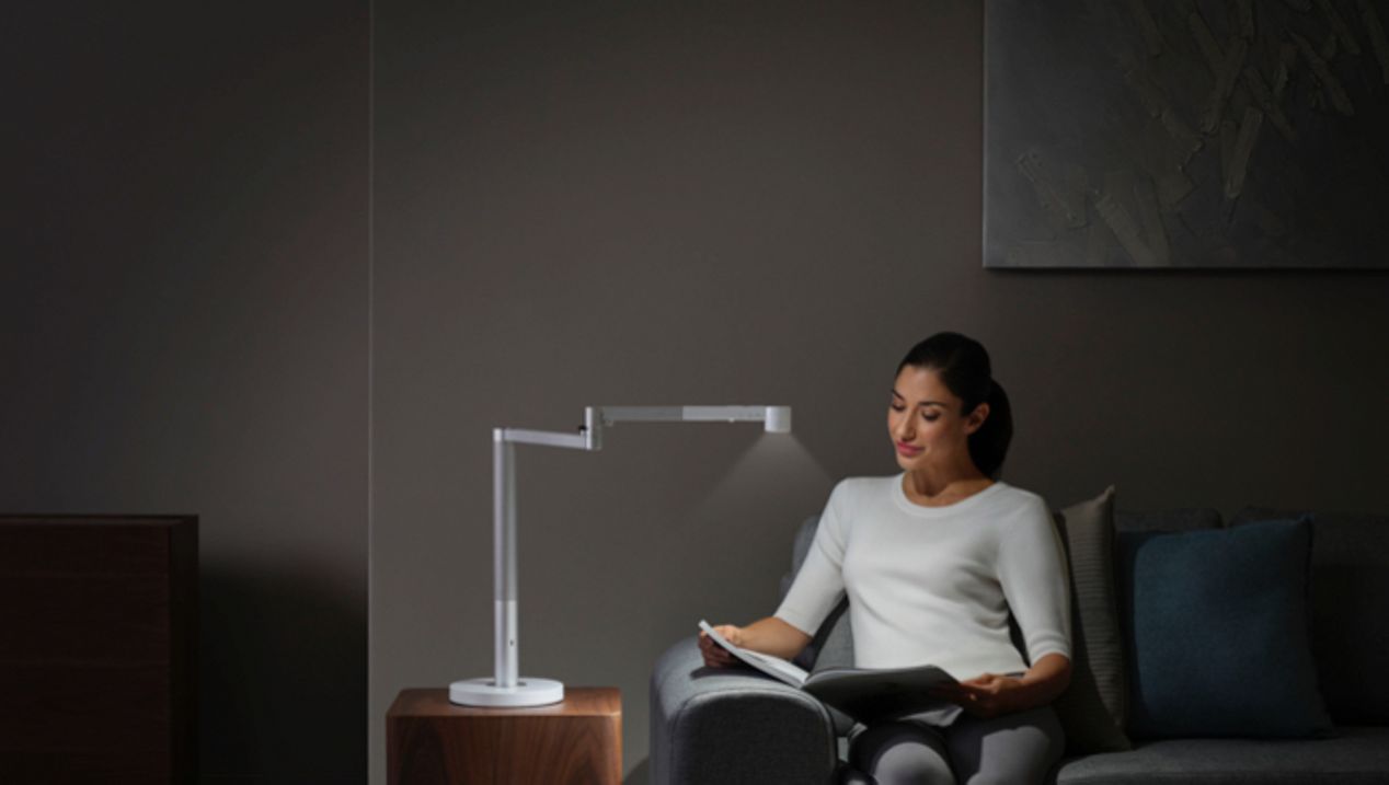 Woman working under the Dyson Lightcycle Morph light in Task position