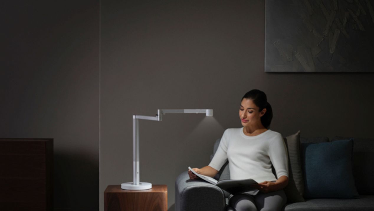 Dyson Lightcycle Morph light in Task position Woman working under the Dyson Lightcycle Morph light in Task position