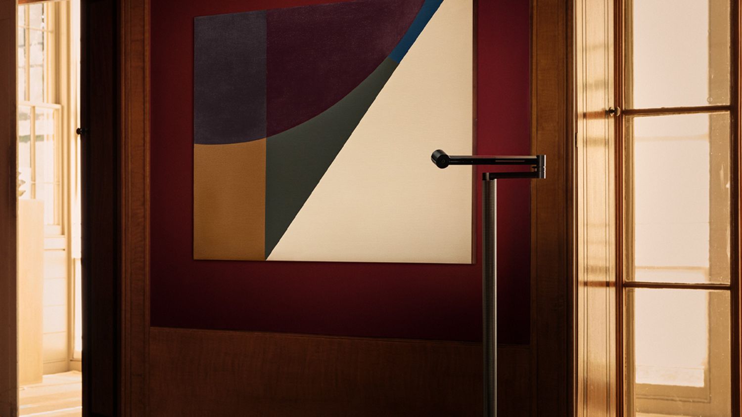  Dyson Solarcycle Morph floor light showcasing artwork on the wall.