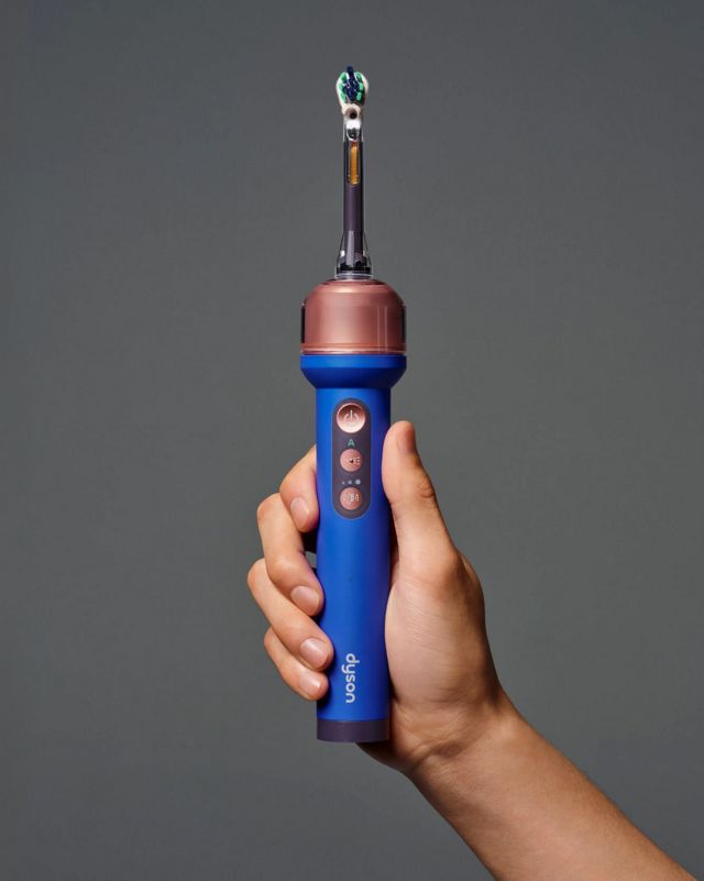 Dyson CameraJet toothbrush in a hand.