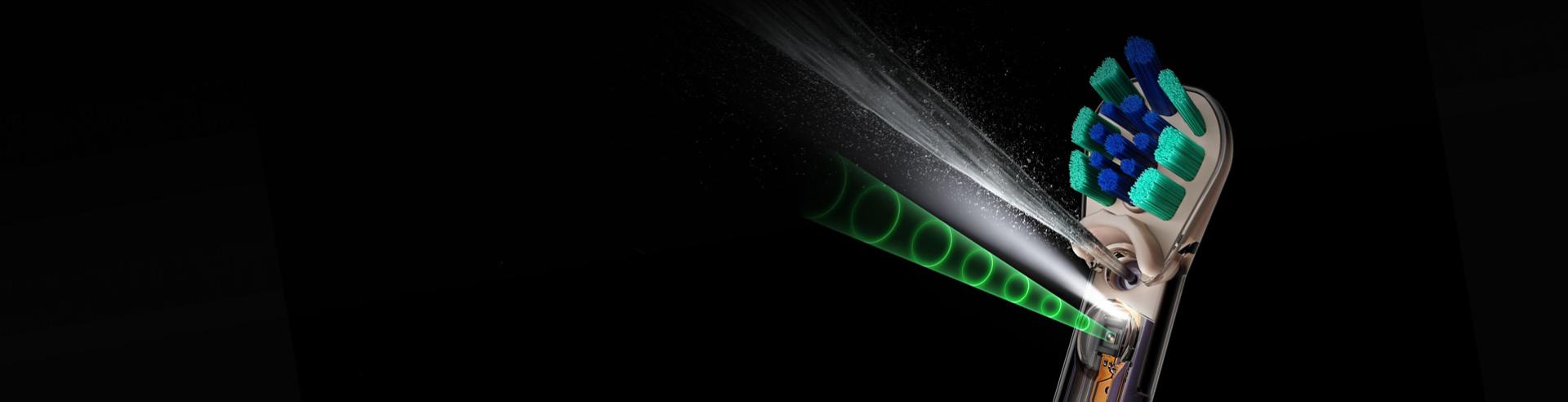Dyson CameraJet toothbrush jets a conical burst of liquid to floss interdental gaps.