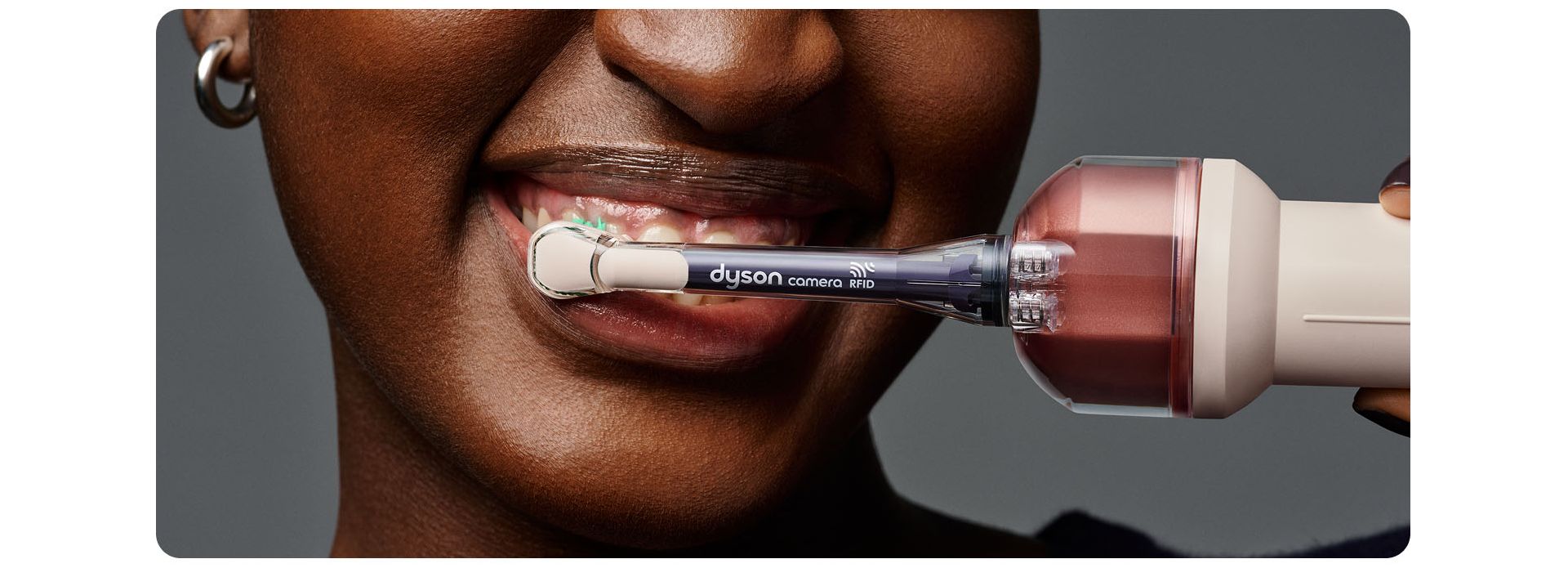 Person brushes their teeth using the Dyson CameraJet toothbrush.