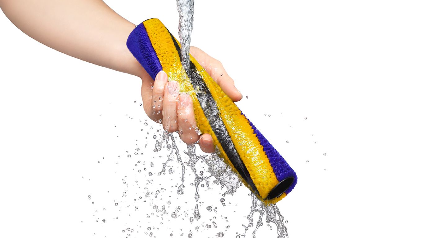 Dyson removable parts being washed in water Dyson removable parts being washed in water