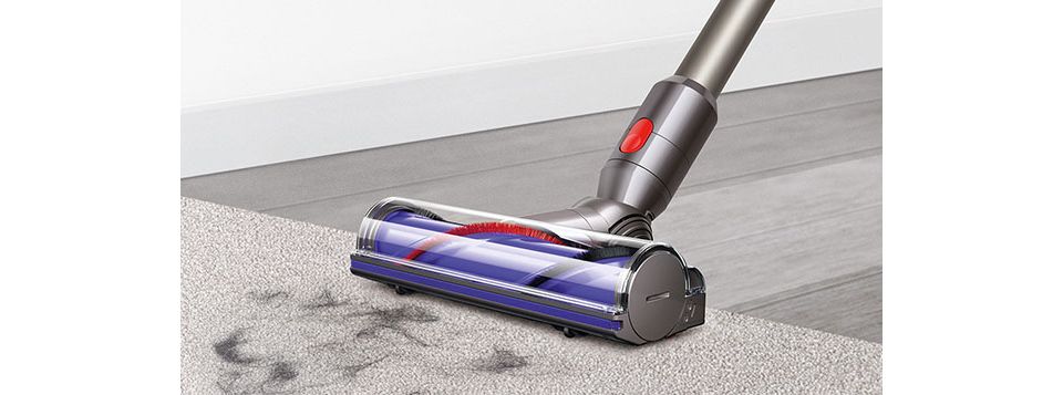 Dyson V8 vacuuming hardwood floor and carpet with pet hair