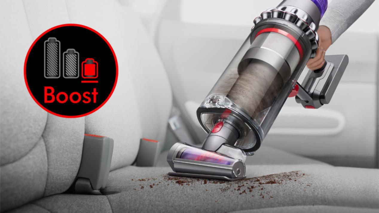 Dyon Outsize in handheld mode cleaning car seats with a Boost mode graphic.