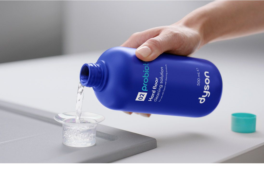 The Dyson 02 Probiotic hard floor cleaning solution is decanted into a measuring cup.