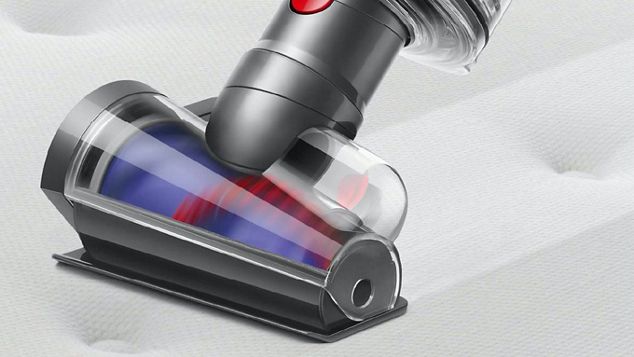 Hair screw tool cleaning a mattress.