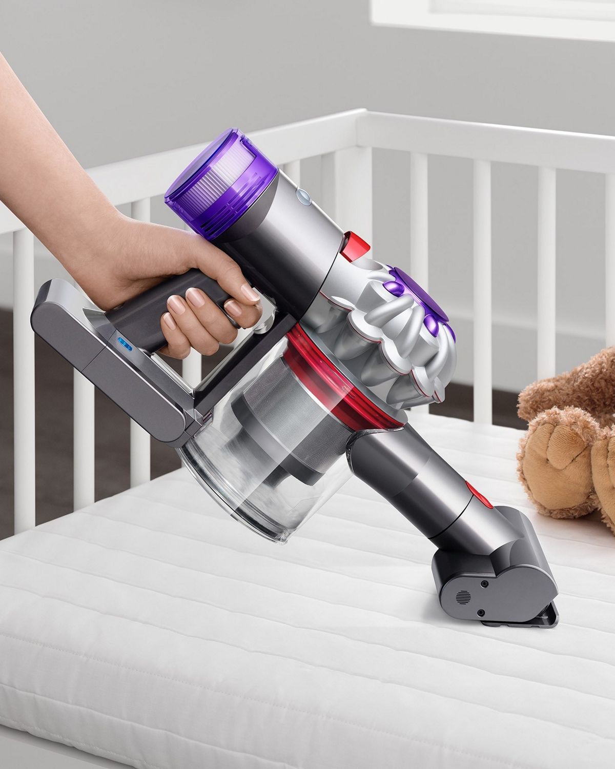 The Dyson Car+Boat handheld vacuum with the Mini motorised tool cleaning a crib mattress.