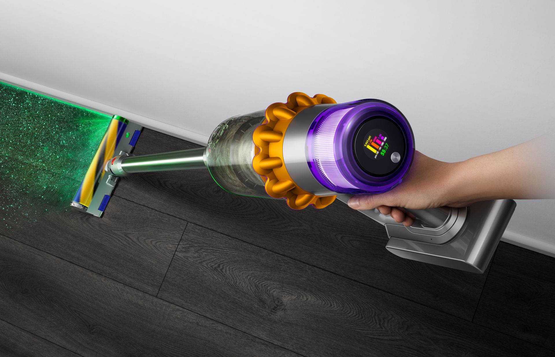 Person vacuuming floor using the Dyson V15 Detect vacuum cleaner