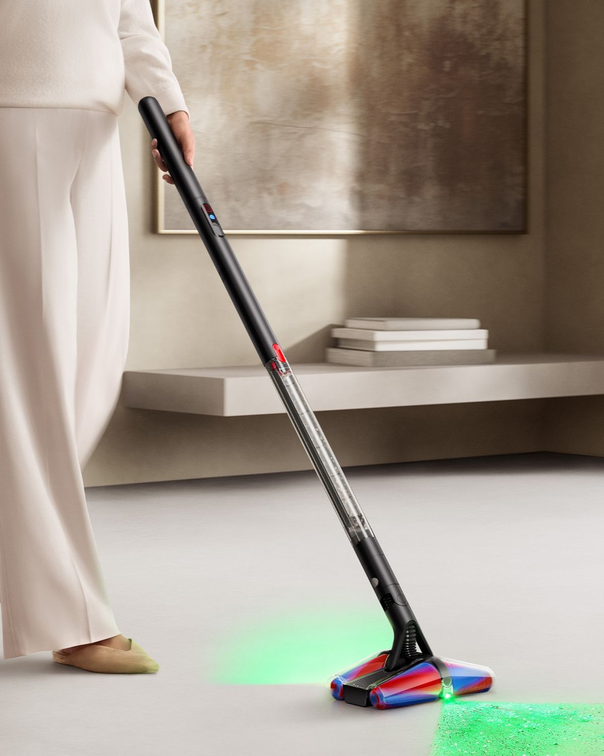 The Dyson PencilVac Fluffycones cleaner is used by a model to illuminate hidden dust and clean floors in their home.