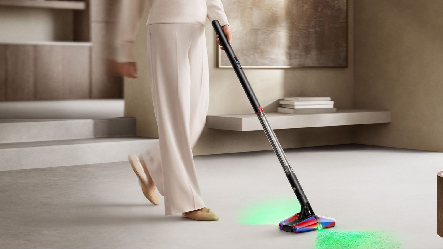 A woman cleaning a hard floor with the Dyson PencilVac showcasing illumination technology.