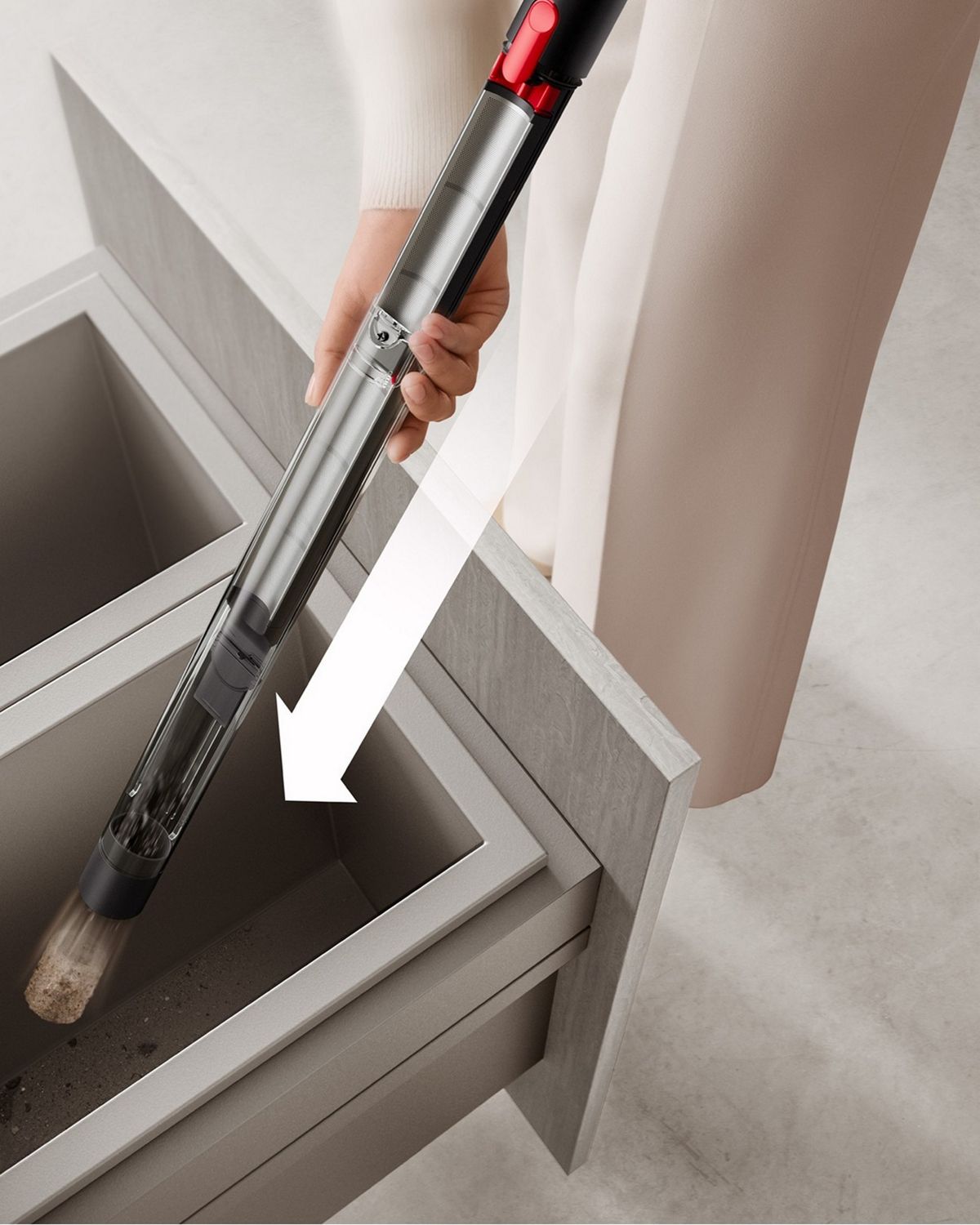 A Dyson PencilVac vacuum having being emptied into a bin.