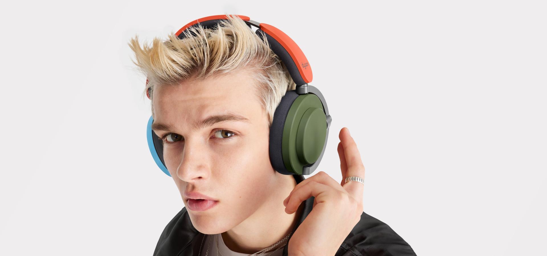 Model taps his Dyson OnTrac headphone to control the sound.