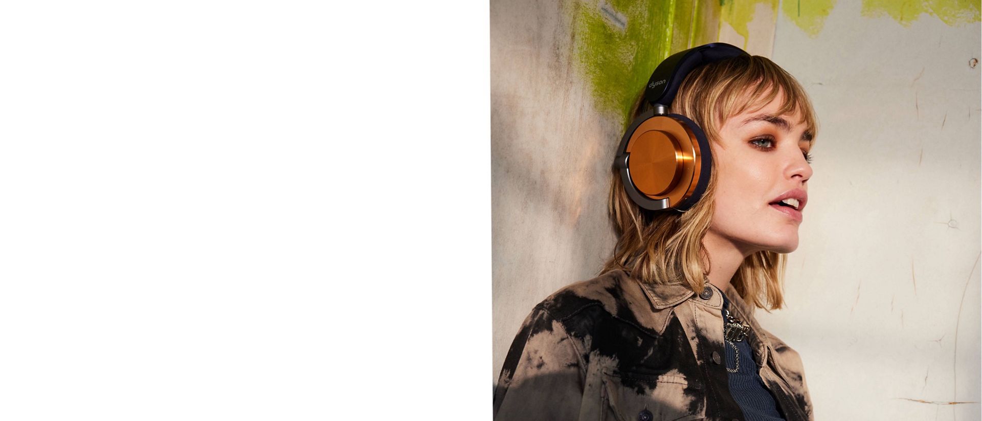 A model wearing Dyson OnTrac headphones with CNC Copper Outer caps.