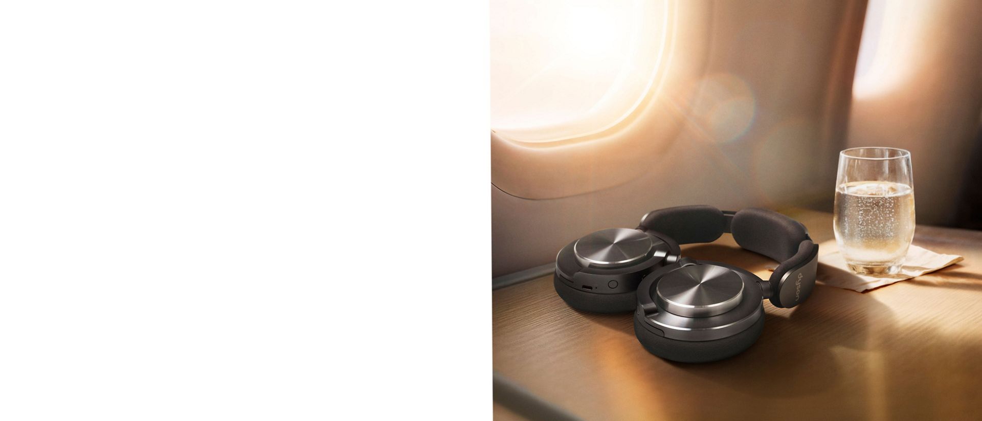 Dyson OnTrac headphones folded flat to lie conveniently on a table.