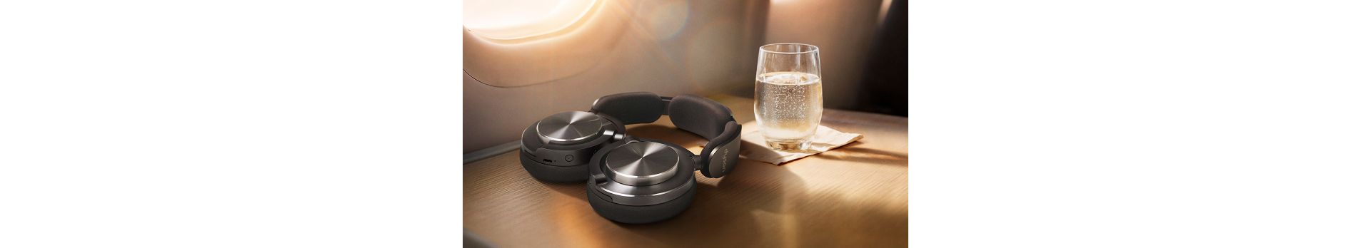 Dyson OnTrac headphones folded flat to lie conveniently on a table.