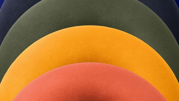 A stack of Dyson OnTrac ear cushions in various colours.