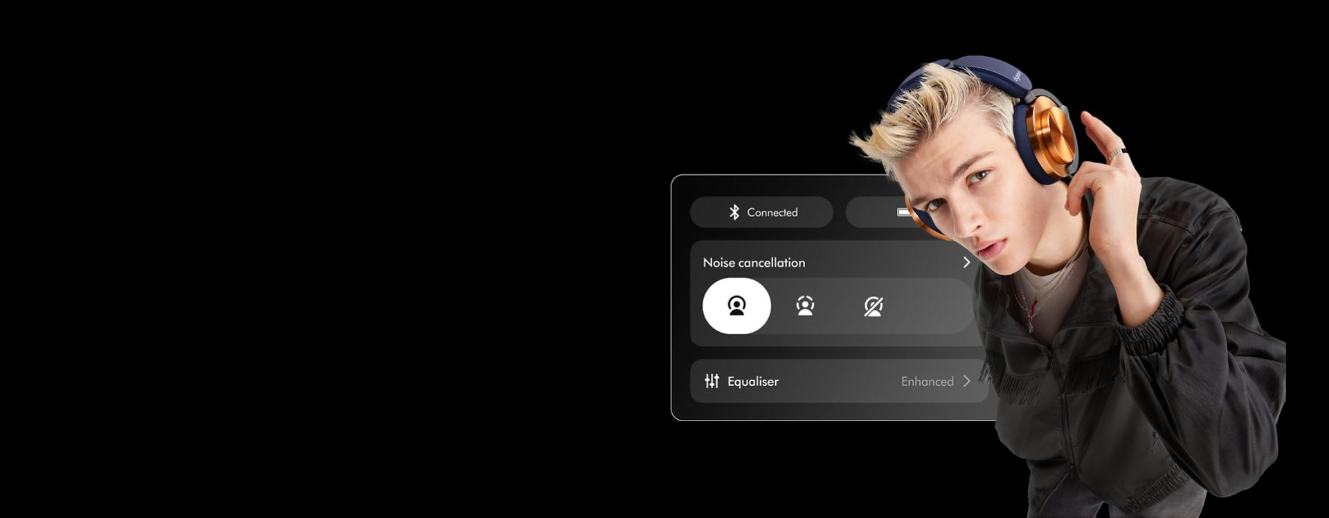 A model looking at the camera while about to tap their Dyson OnTrac headphones. Behind them is an image of the app screen.
