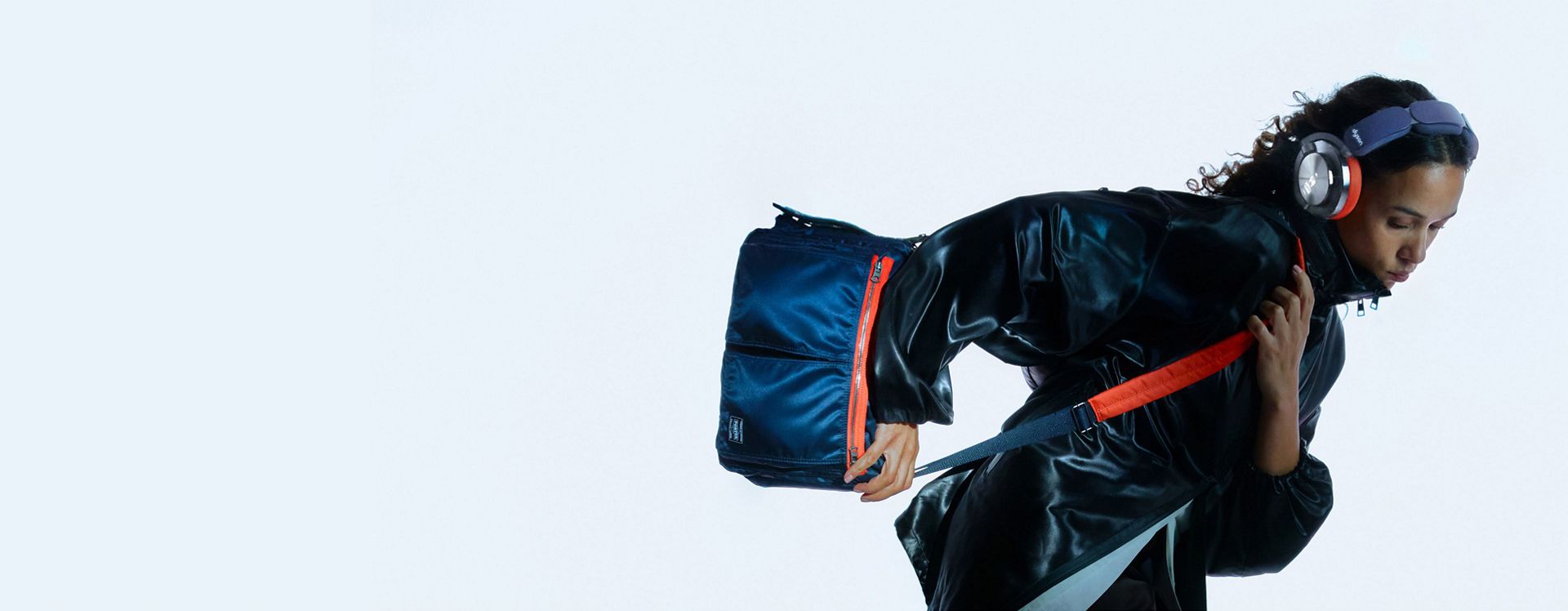 Model wearing Dyson OnTrac and PORTER custom shoulder bag.