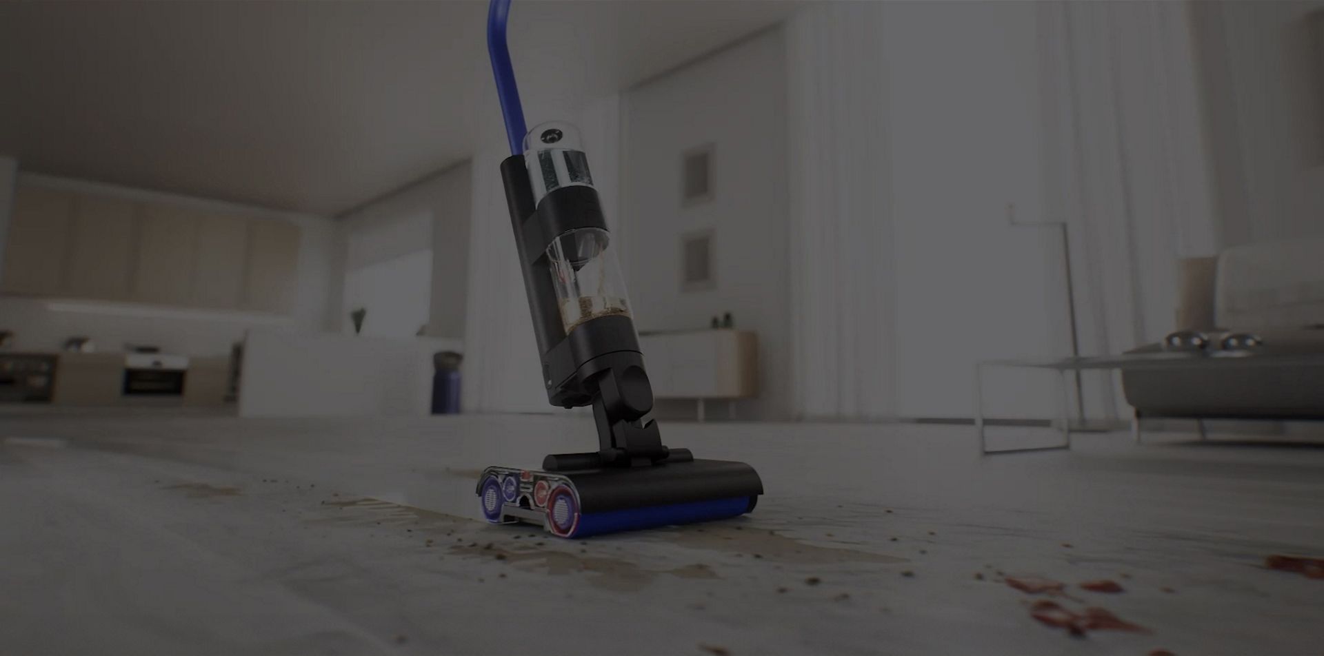 The Dyson WashG1 cleaning debris and spills on a hard floor in a living room