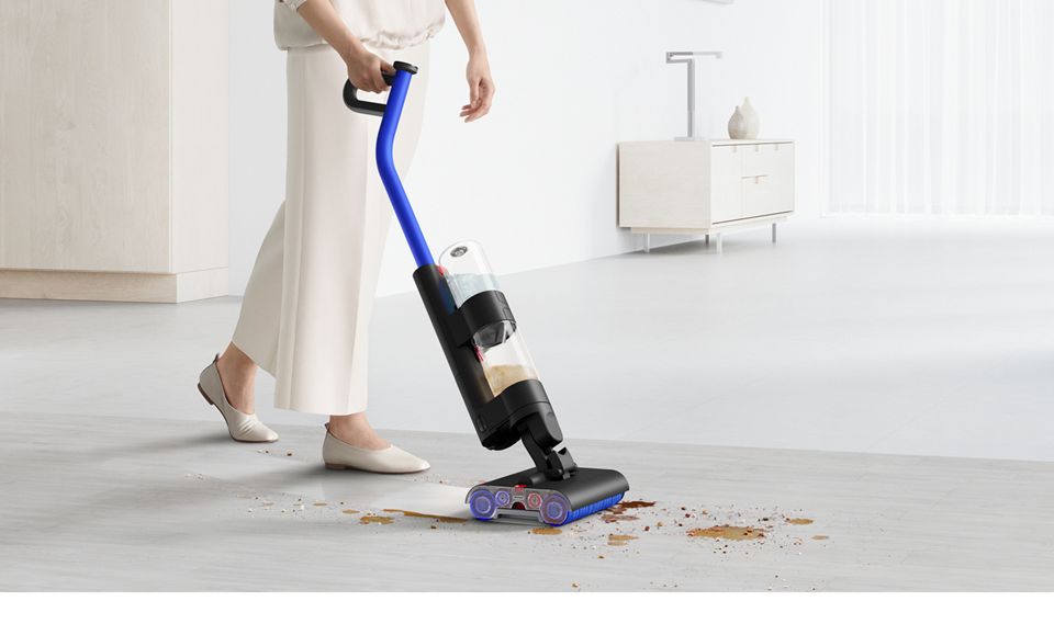 Dyson WashG1 wet cleaner cleaning debris and spills on a hard floor