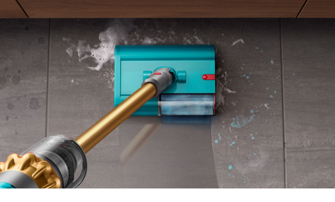Dyson wet and dry cleaner removing debris and spills on a tile floor