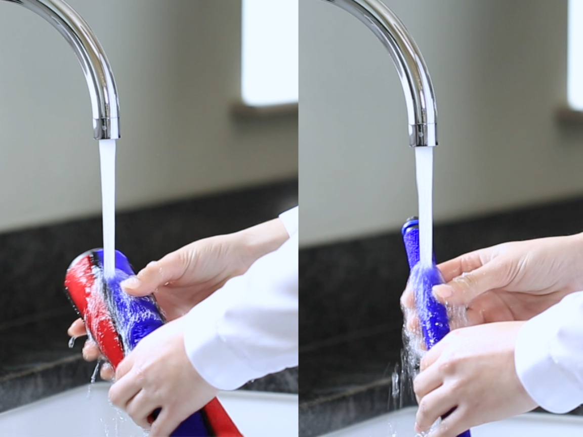 cleaning Dyson soft roller brush bar under running water