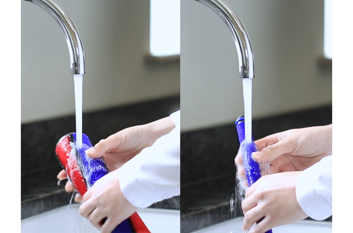 cleaning Dyson soft roller brush bar under running water