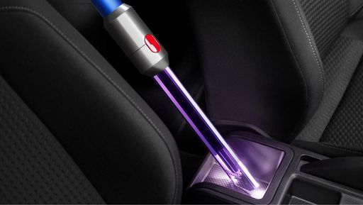 Cleans hard-to-reach spaces Light pipe crevice tool cleaning a dark car interior