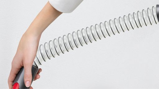 Woman using Extension hose for flexible reach Woman using Extension hose for flexible reach