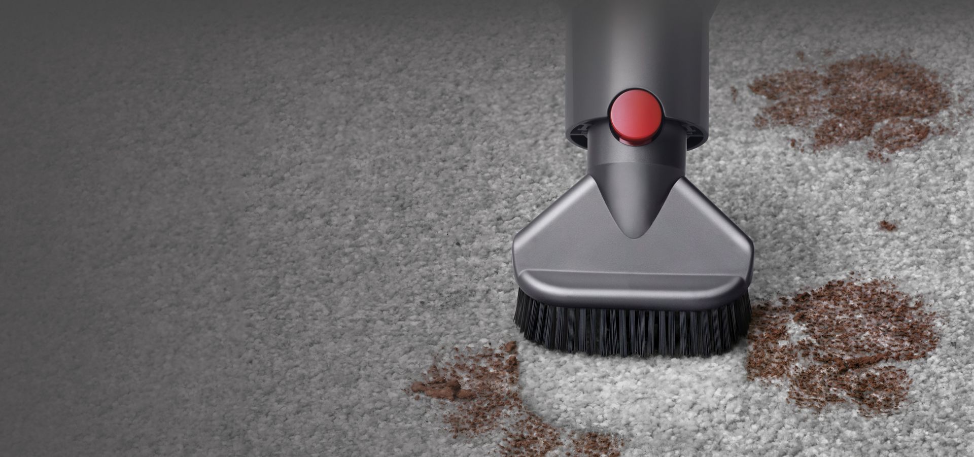 Close up of Stubborn dirt vacuum tool being used to vacuum dirt on a carpet