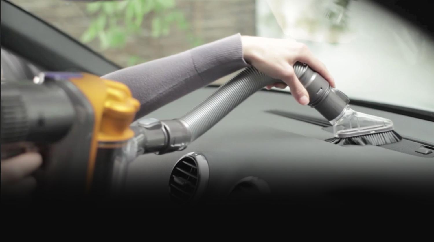 Extension hose and mini soft dusting brush on car dashboard