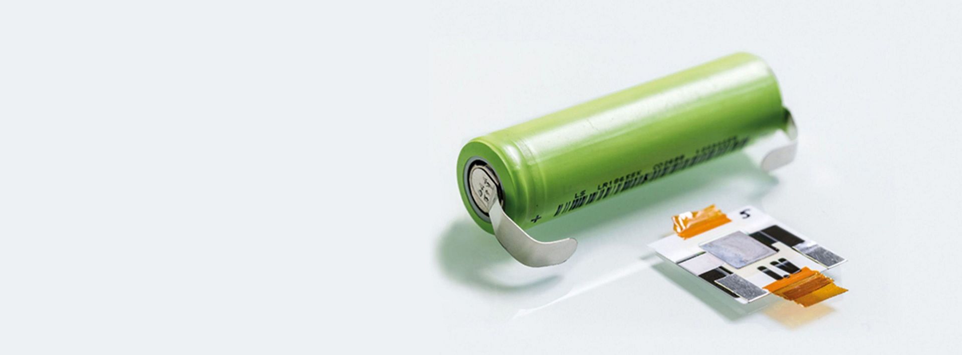 Battery cells next to a battery shell.