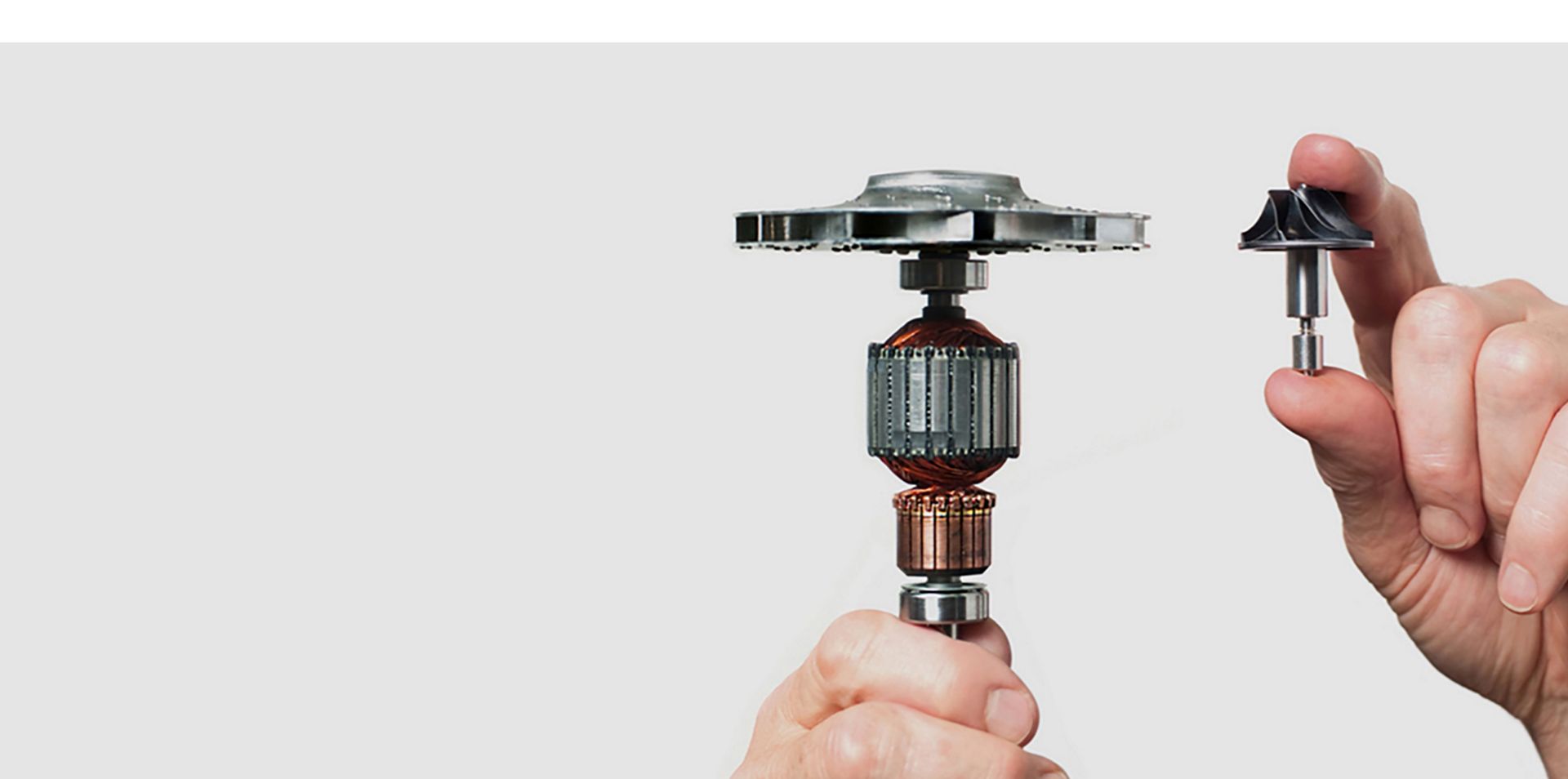 Person holding the old and new Dyson digital motors.